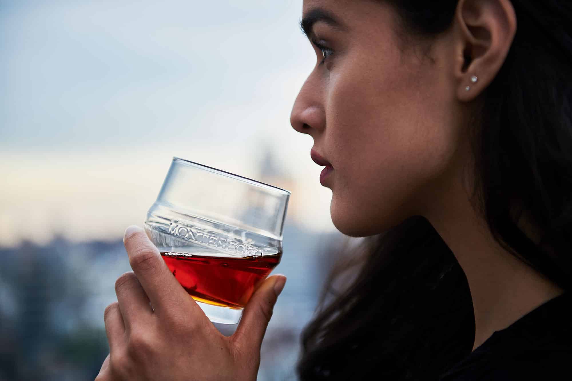 commercial beverage photography of girl sipping Amaro Montengro